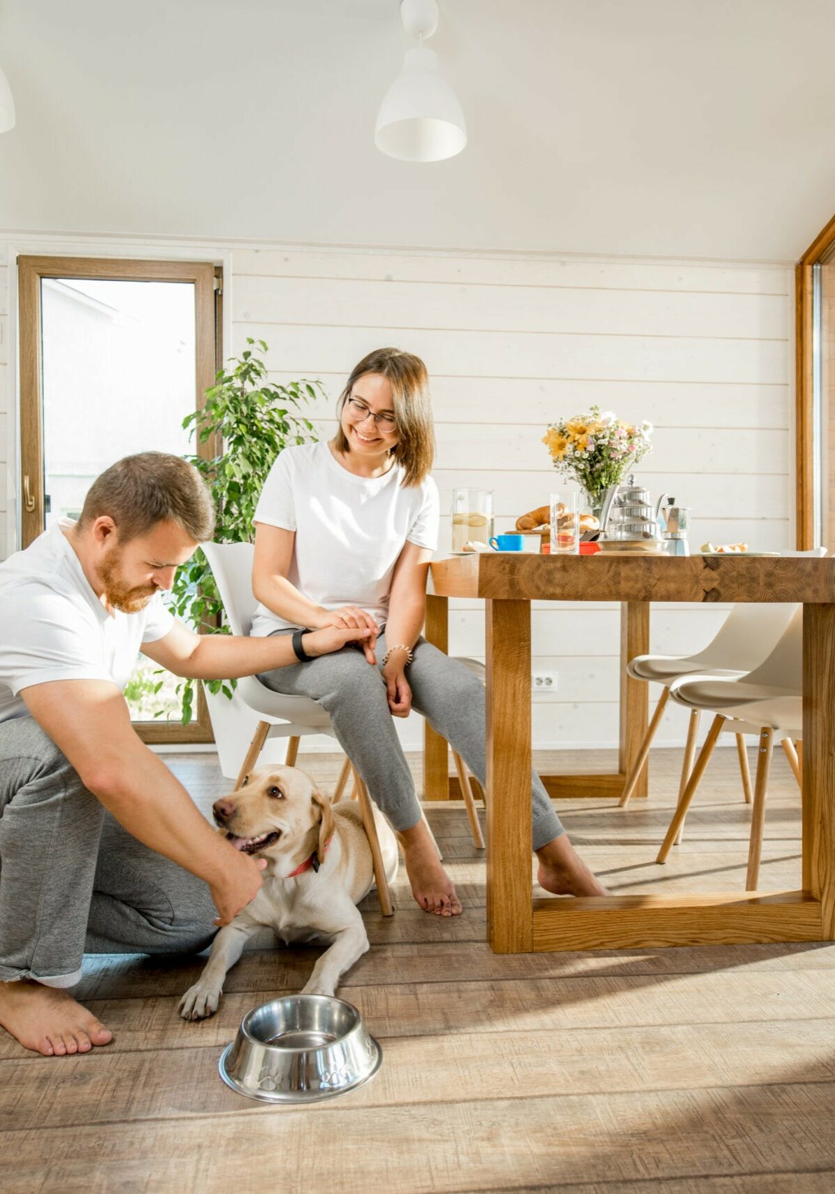 Young couple with dog at home | Budget Floors
